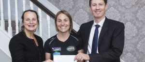 Niamh Ni Mhurchu and Brian Gill Partners presenting Laura Tighe with sponsorship cheque.